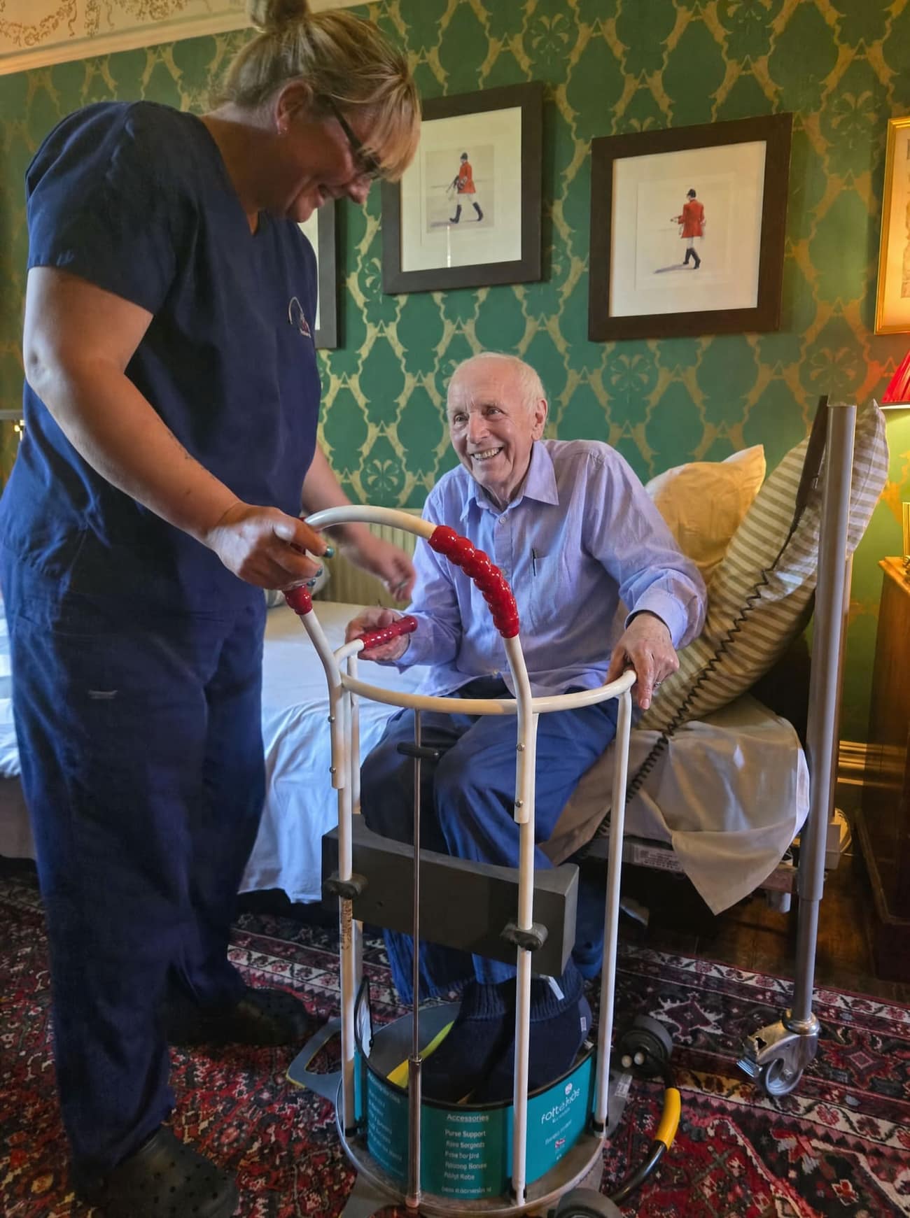 Carer helping a client stand up in the lounge at home